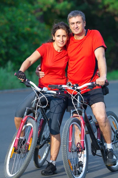 Mature couple on bicycle — Stock Photo, Image