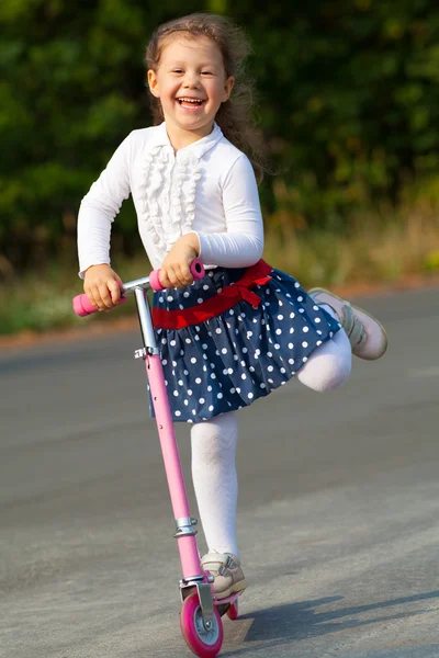 Happy girl on scooter — Stock Photo, Image