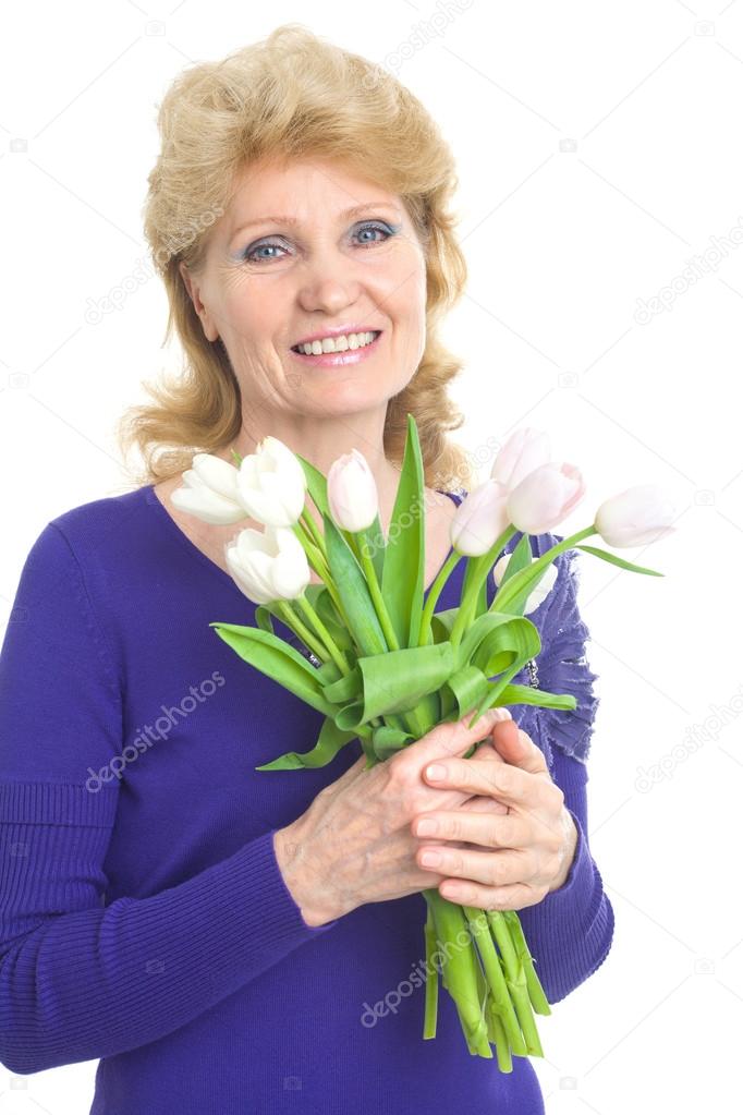 Beautiful woman of advanced age with a bouquet of tulips