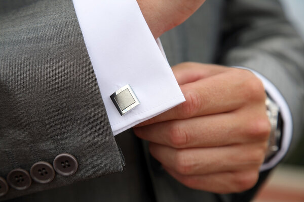 Man fastening a cuff-link