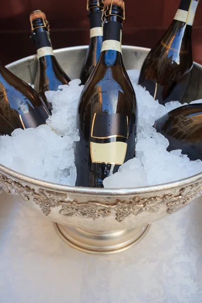 Wine bottles in cold ice bucket — Stock Photo, Image