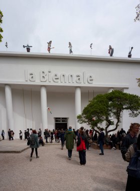 Venice, Italy - April 20: Visitors at the Giardini during the 59th International Art exhibition of Venice biennale titled The Milk of dreams on April 20, 2022 clipart