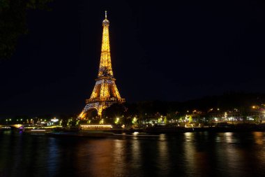 Paris, France - July, 13: Eiffel Tower brightly illuminated at dusk in Paris. It's the most visited monument of France on 13 July, 2022