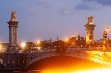 Pont Alexandre III Bridge and illuminated lamp posts at sunset. 7th Arrondissement, Paris, France