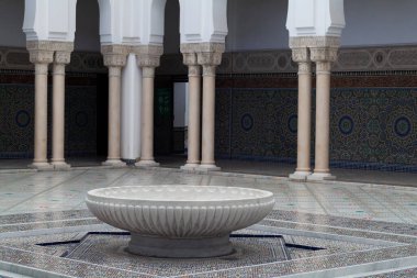 The large marble basin in the middle of the Grand Mosque of Paris full of beautiful mosaics