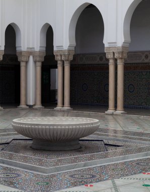 The large marble basin in the middle of the Grand Mosque of Paris full of beautiful mosaics