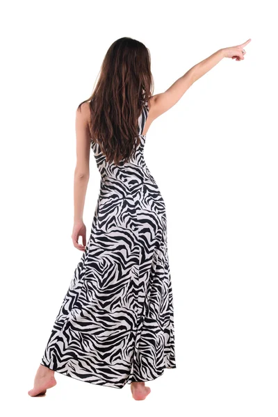 ドレスを指すで美しい若い女性の背面図 — ストック写真