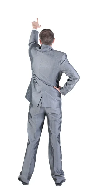 Back view of businessman pointing at wall — Stock Photo, Image