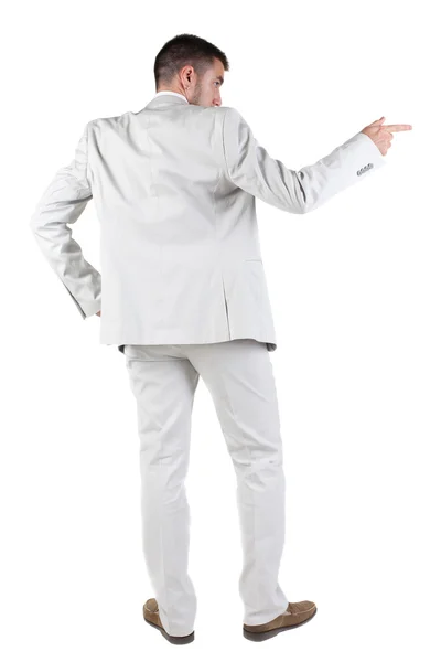 Back view of businessman pointing at wall Royalty Free Stock Images