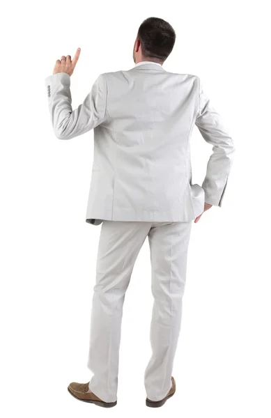 Back view of thinking young business man in white suit. Stock Photo