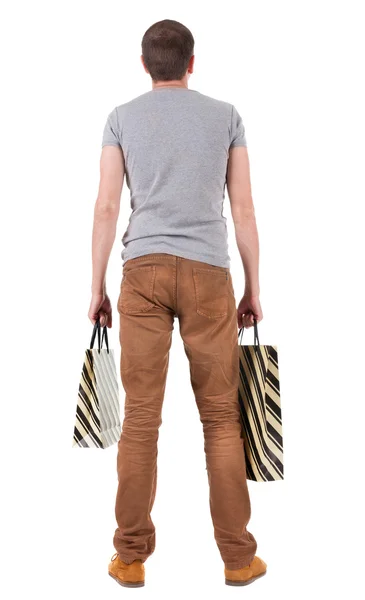 Vista posterior de hombre guapo con bolsas de compras — Foto de Stock