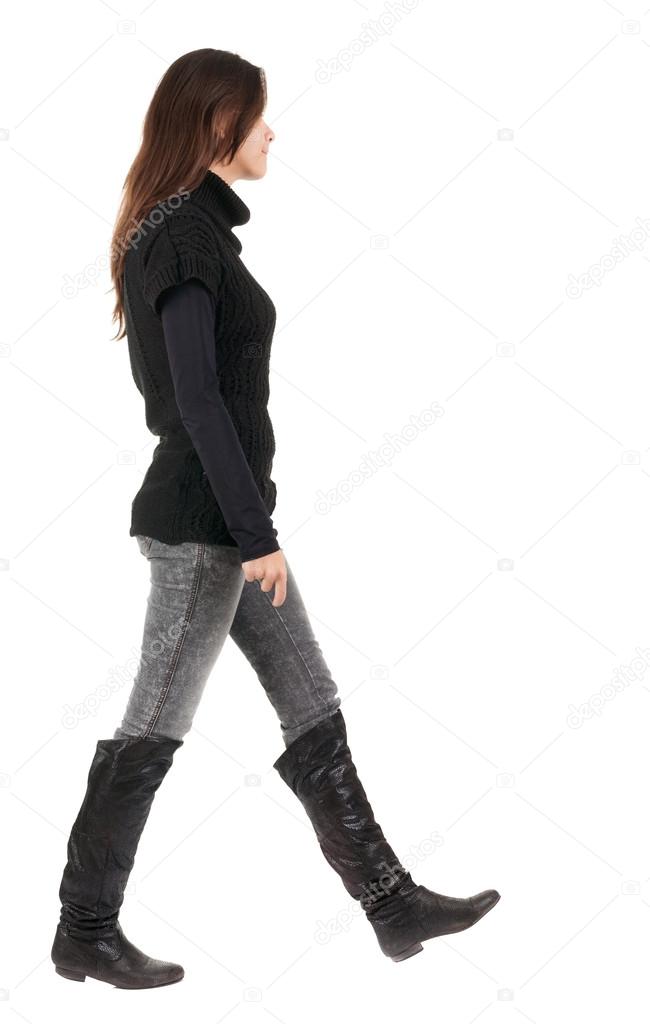 back view of going woman in jeans and sweater