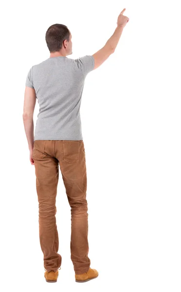 Задний вид указания молодых людей в рубашке и джинсах — стоковое фото