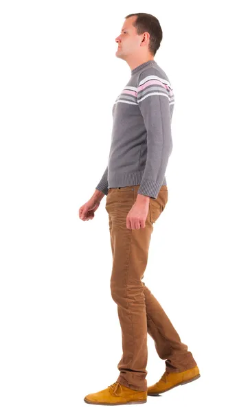 Back view of going man in sweater and brown jeans. — Stock Photo, Image