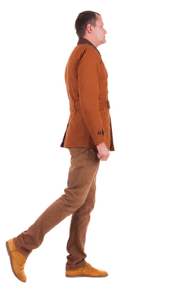 Bakifrån Walking stilig man i jeans och jacka. — Stockfoto
