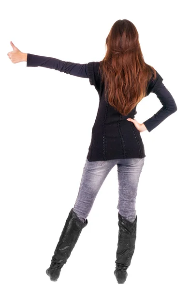 Back view of of beautiful brunette woman in jeans going thumb up — Stock Photo, Image