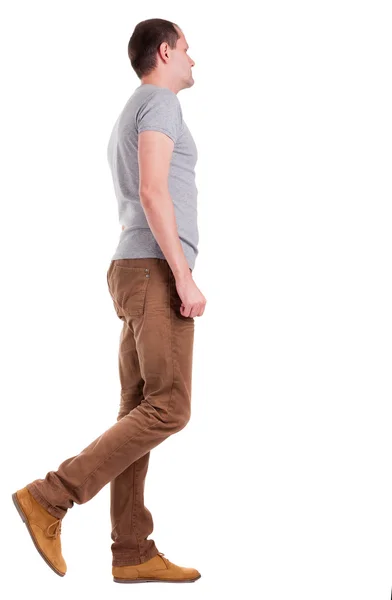 Back view of going handsome man in jeans and a shirt — Stock Photo, Image