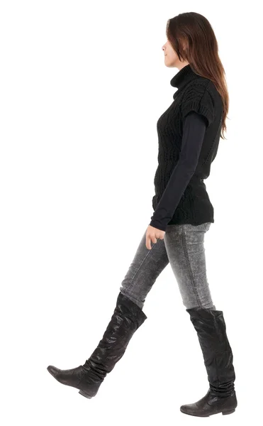 Back view of going woman in jeans and sweater — Stock Photo, Image