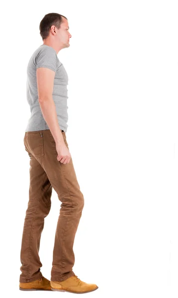 Vista trasera de un hombre guapo en jeans y una camisa . — Foto de Stock
