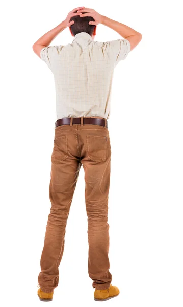 Back view of angry young man in jeans and shirt. — Stock Photo, Image