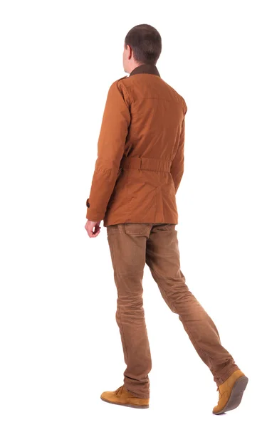 Bakifrån av vandrande affärsman i jeans och jacka — Stockfoto