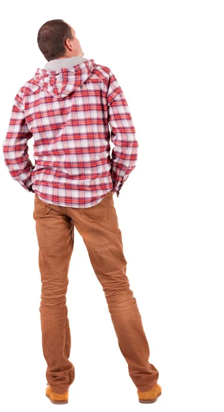 Bakifrån av kille i en rutig tröja med huva ser — Stockfoto