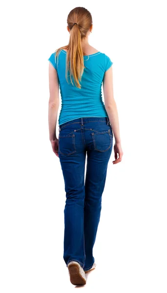 Back view of walking woman in jeans and shirt. — Stock Photo, Image