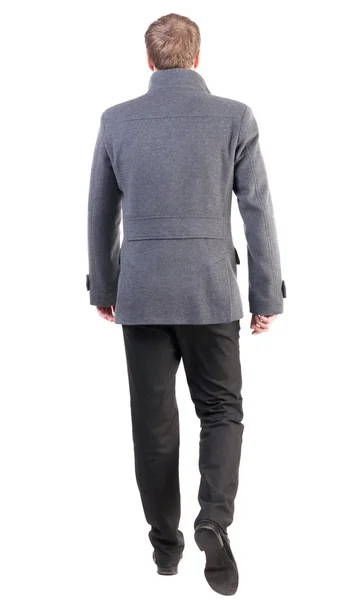 Back view of going handsome business man in coat - Stock-foto