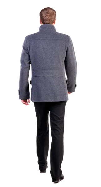 Back view of going handsome business man in coat. — Stock Photo, Image