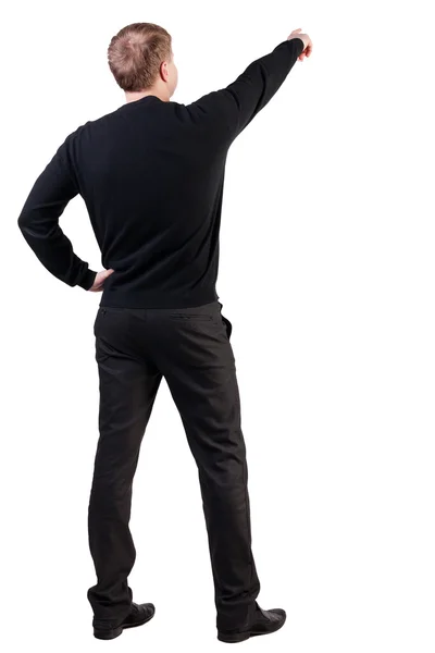 セーターの若いビジネスの男性を指すの背面図. — ストック写真