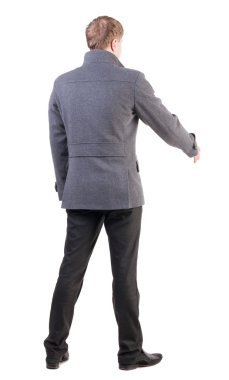 back view of businessman in coat reaches out to shake hands. clipart