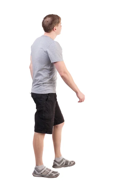 Back view of walking handsome man in shorts and sneakers — Stock Photo, Image