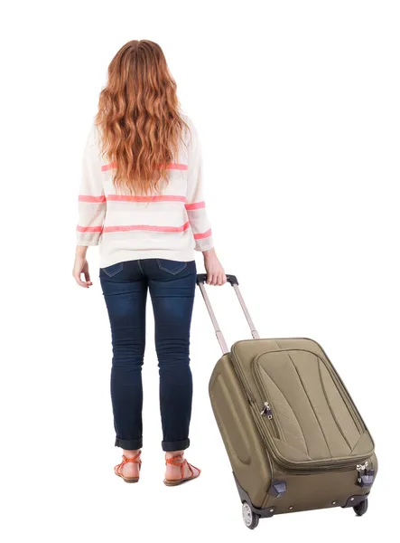 Back view of walking woman with suitcase. — Fotografia de Stock