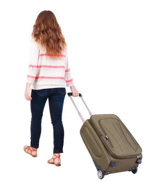 Back view of walking woman with suitcase — Stock Photo, Image