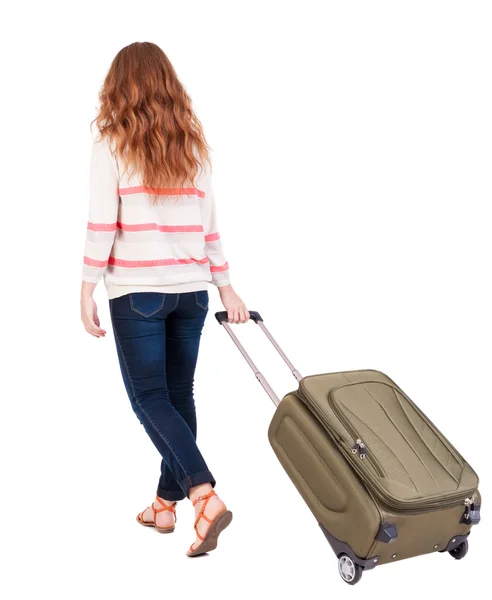 Back view of walking woman with suitcase. — Stock Photo, Image