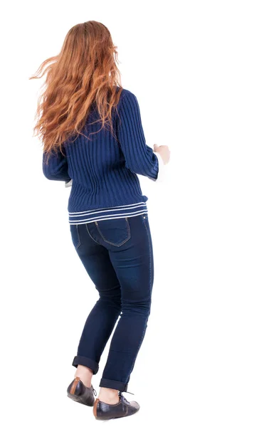 Back view of jumping woman in jeans — Stock Photo, Image