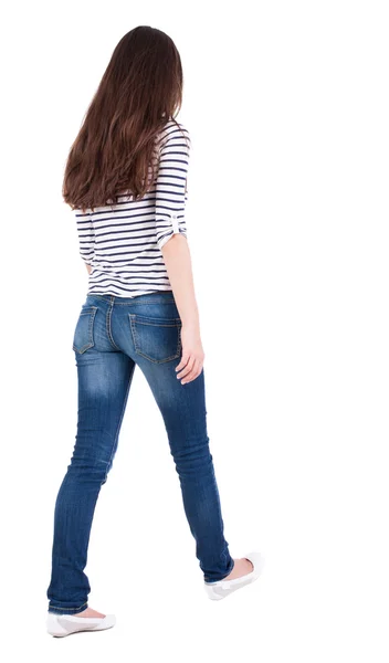 Back view of walking woman in jeans — Stockfoto