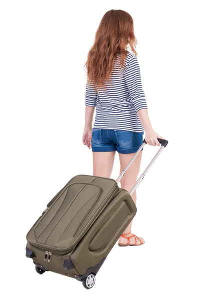 Back view of walking woman with suitcase — Stock Photo, Image