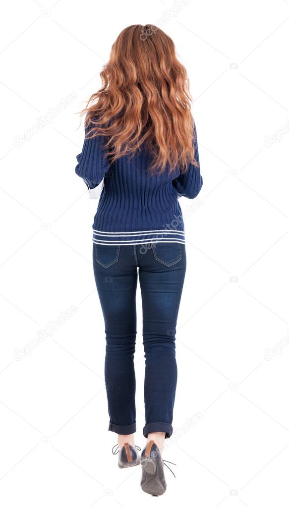 back view of jumping woman in jeans