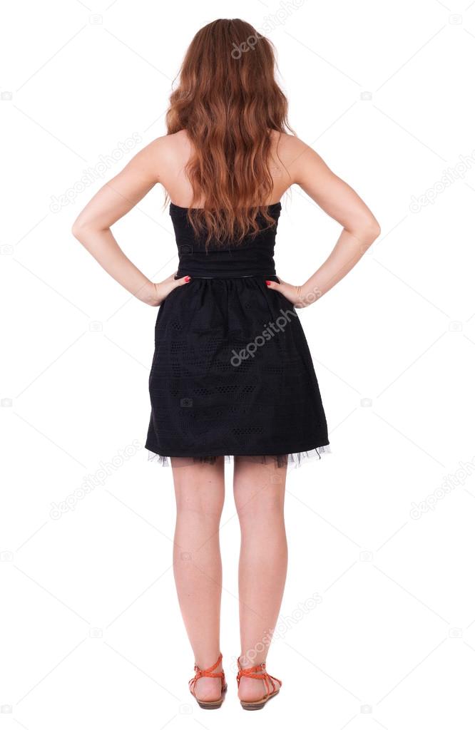 back view of standing young beautiful woman With long red curly