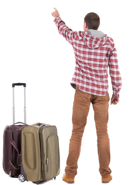 Visão de homem com mala apontando a viajar de volta. vista traseira peo — Fotografia de Stock