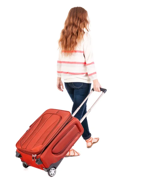 Back view of walking woman with suitcase. — Stock Photo, Image