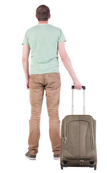 Back view of man with green suitcase looking up – stockfoto