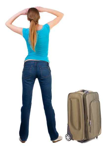 Back view of blonde woman with suitcase looking up. — Stock Photo, Image