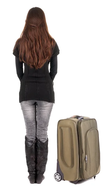 Vista posterior de mujer morena en jeans con loo maleta de viaje —  Fotos de Stock