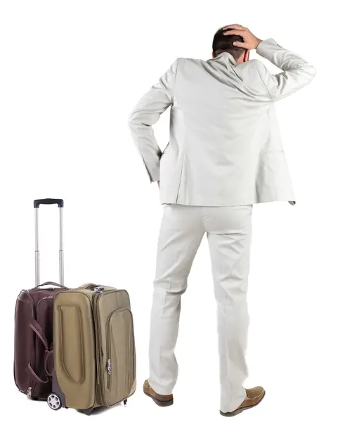 Powrót widok zszokowany biznes człowiek z walizką patrząc. — Zdjęcie stockowe