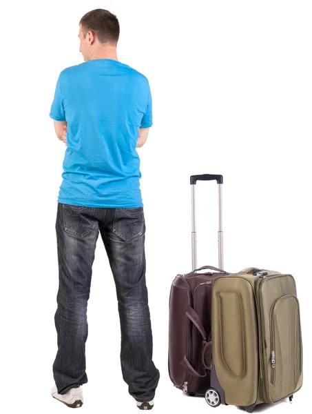 Back view of traveling man with suitcase looking up. — Stock Photo, Image