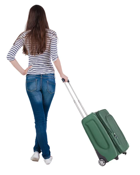 Back view of stylishly dressed brunette woman with suitcase lo — Stock Photo, Image