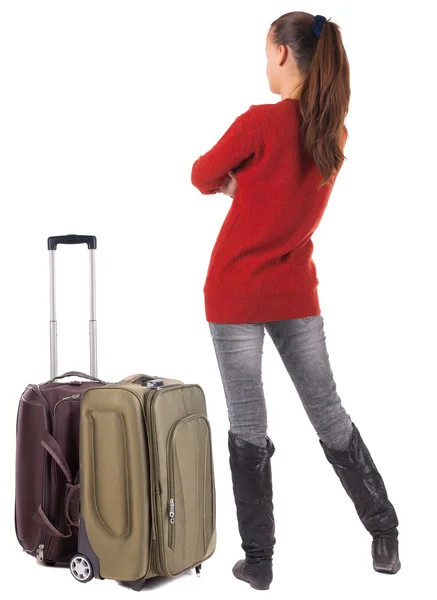 Powrót widok podróży brunetka dama w dżinsy z walizka loo — Zdjęcie stockowe