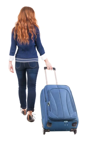 Back view of walking woman with suitcase — Fotografia de Stock